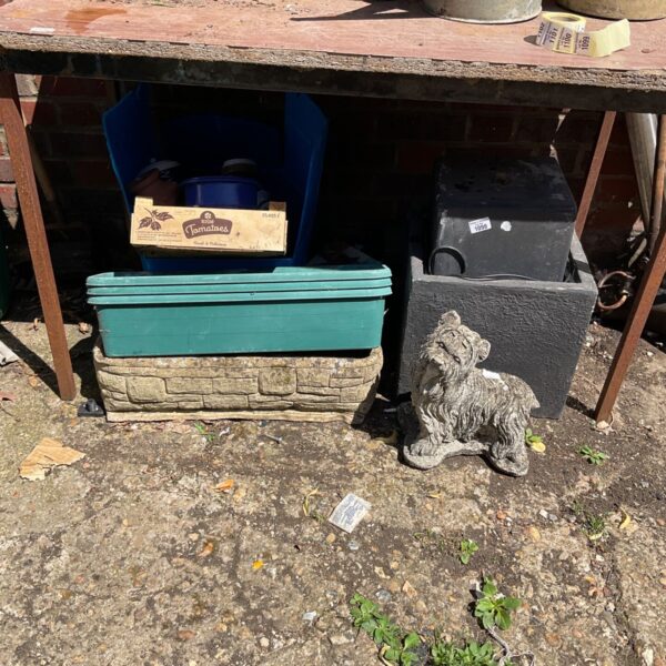 Garden ornament lot featuring a dog statue and planters.