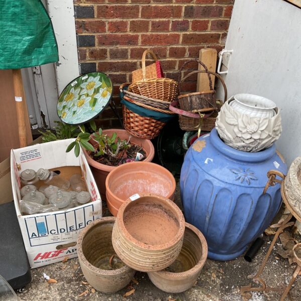 Job lot of vintage garden planters and woven baskets for outdoor use.