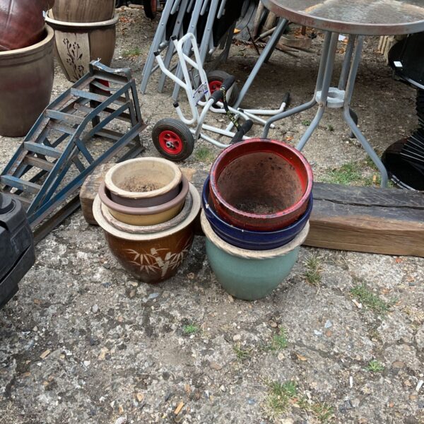 Assorted vintage garden planters in terracotta and ceramic.