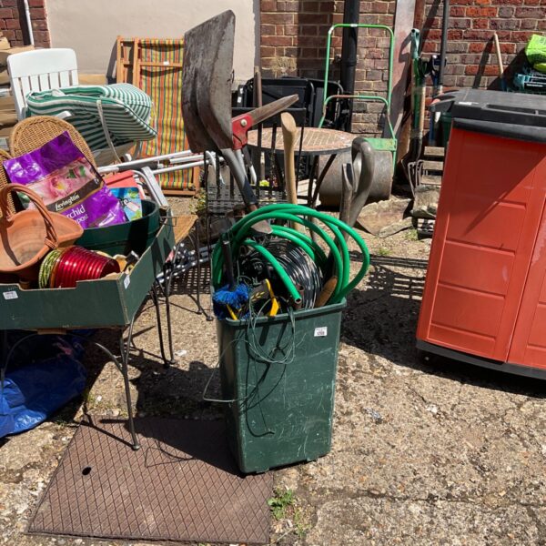 Selection of used garden tools including a shovel and trowel.