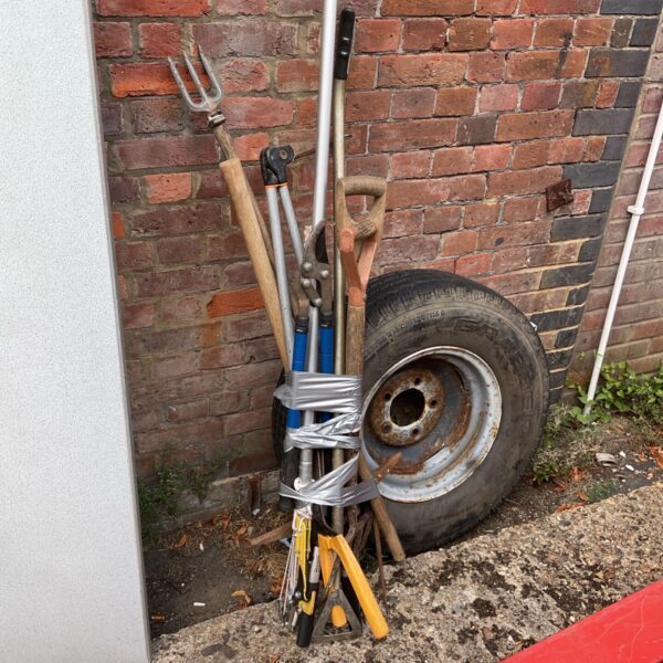 Selection of vintage garden tools including a fork and spade.