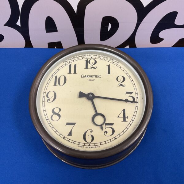 Vintage Garnetric British Clocks electric wall clock with a cream face.