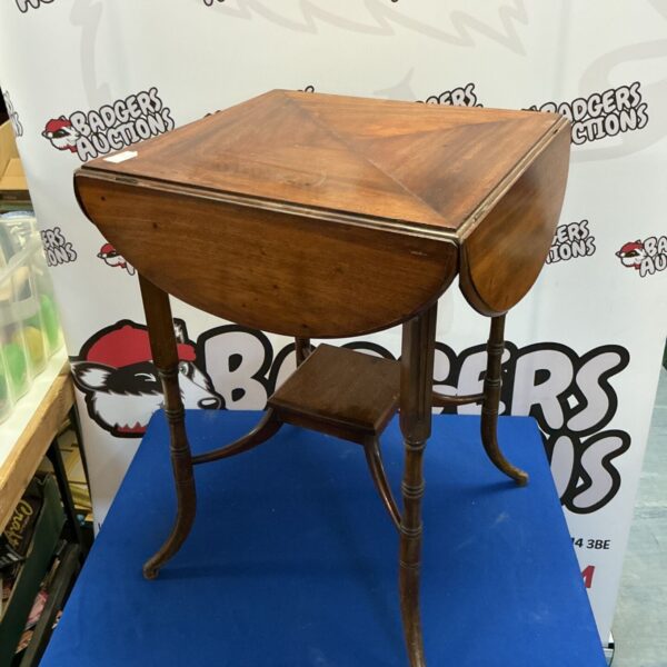 Antique Georgian mahogany drop leaf table with carved legs.