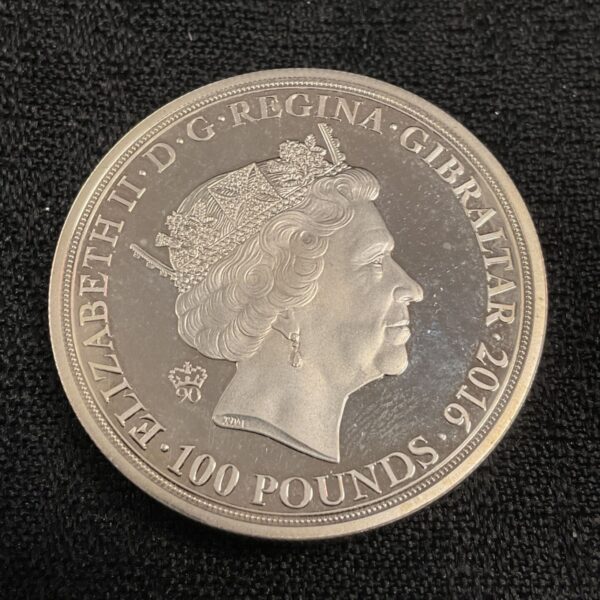 Silver £100 coin featuring Queen Elizabeth II portrait.