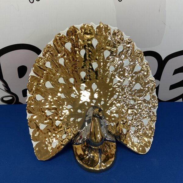 Large gilded porcelain peacock wall hanging, detailed gold feathers.