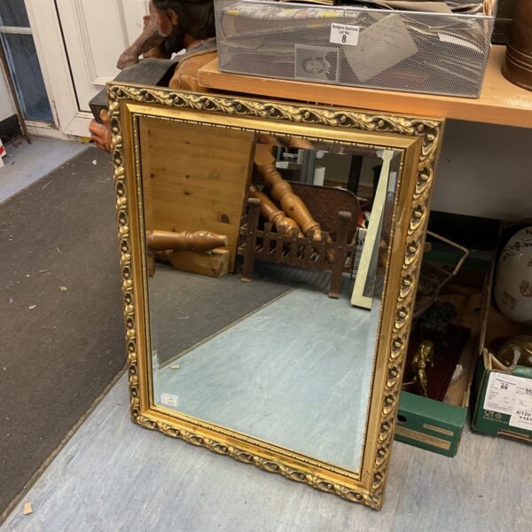 Antique gilt framed bevel edged rectangular mirror for wall decoration.