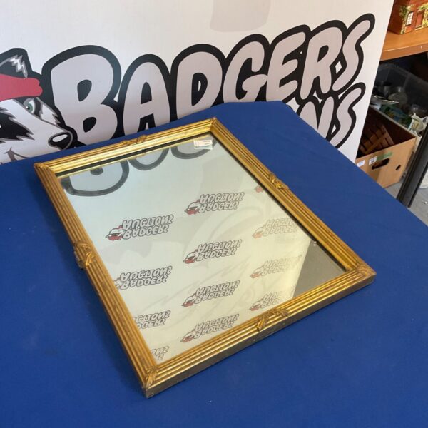 Ornate gilt framed mirror, 20 by 15 inches, vintage style.