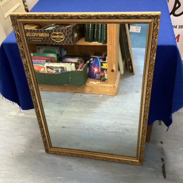Ornate gilt framed mirror for vintage home decor.