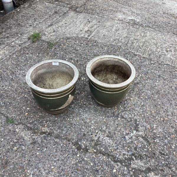 Pair of green glazed garden pots in an outdoor setting.