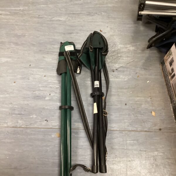 Pair of green folding camping chairs for outdoor use.