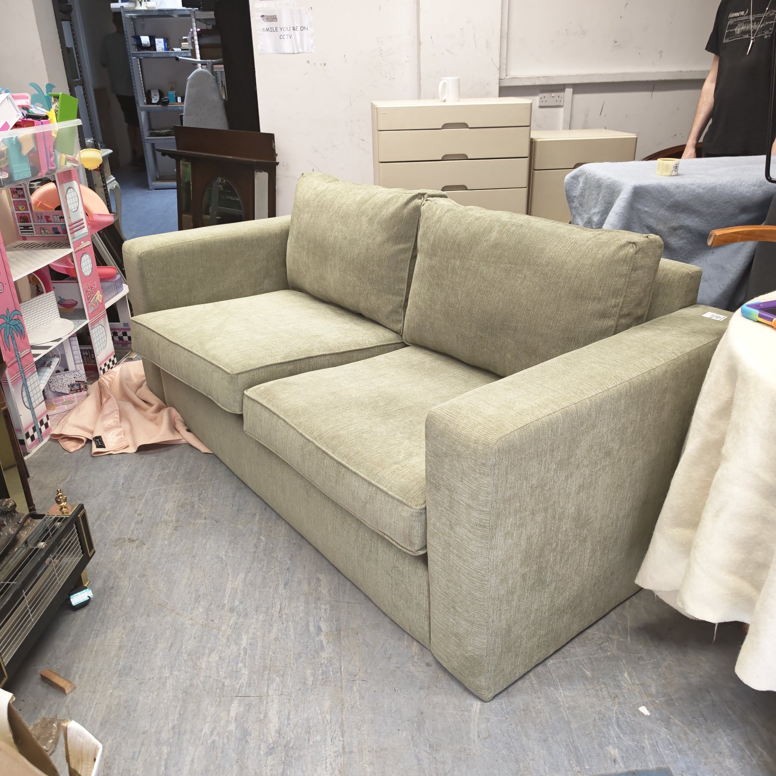 Modern green fabric sofa in a room setting.