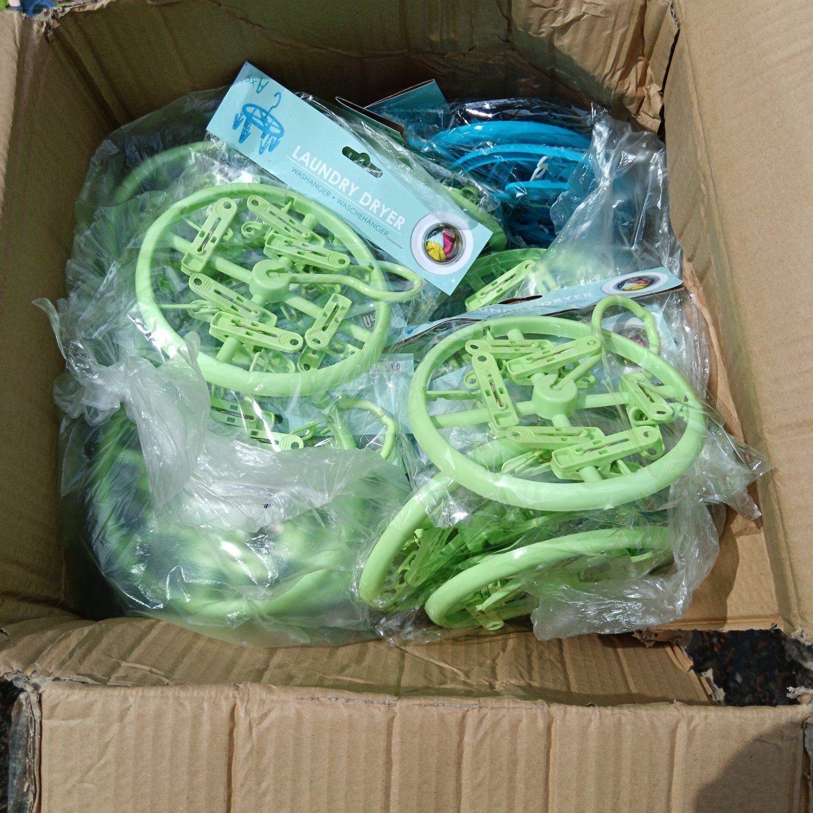 Stack of green plastic laundry dryers for efficient clothes drying.