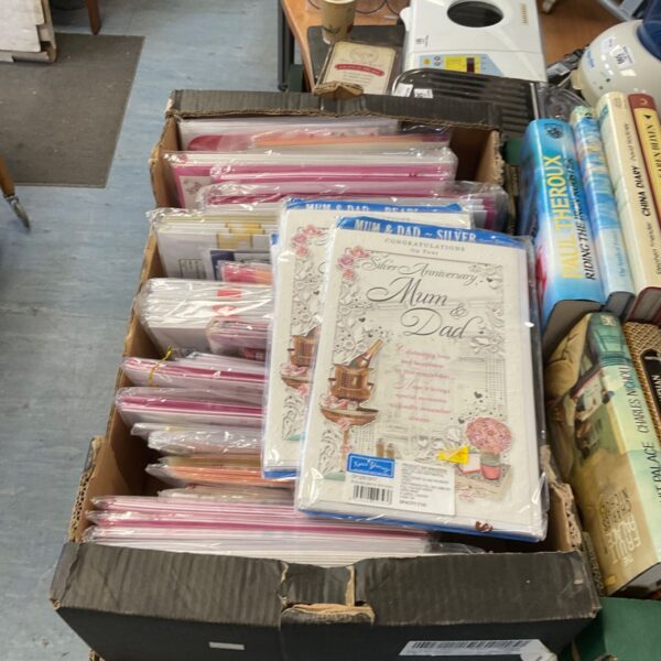 Assorted greeting cards in boxes, a colourful card collection.