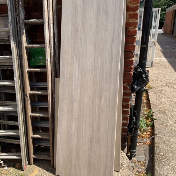 Grey laminate kitchen worktop leaning against a wall.