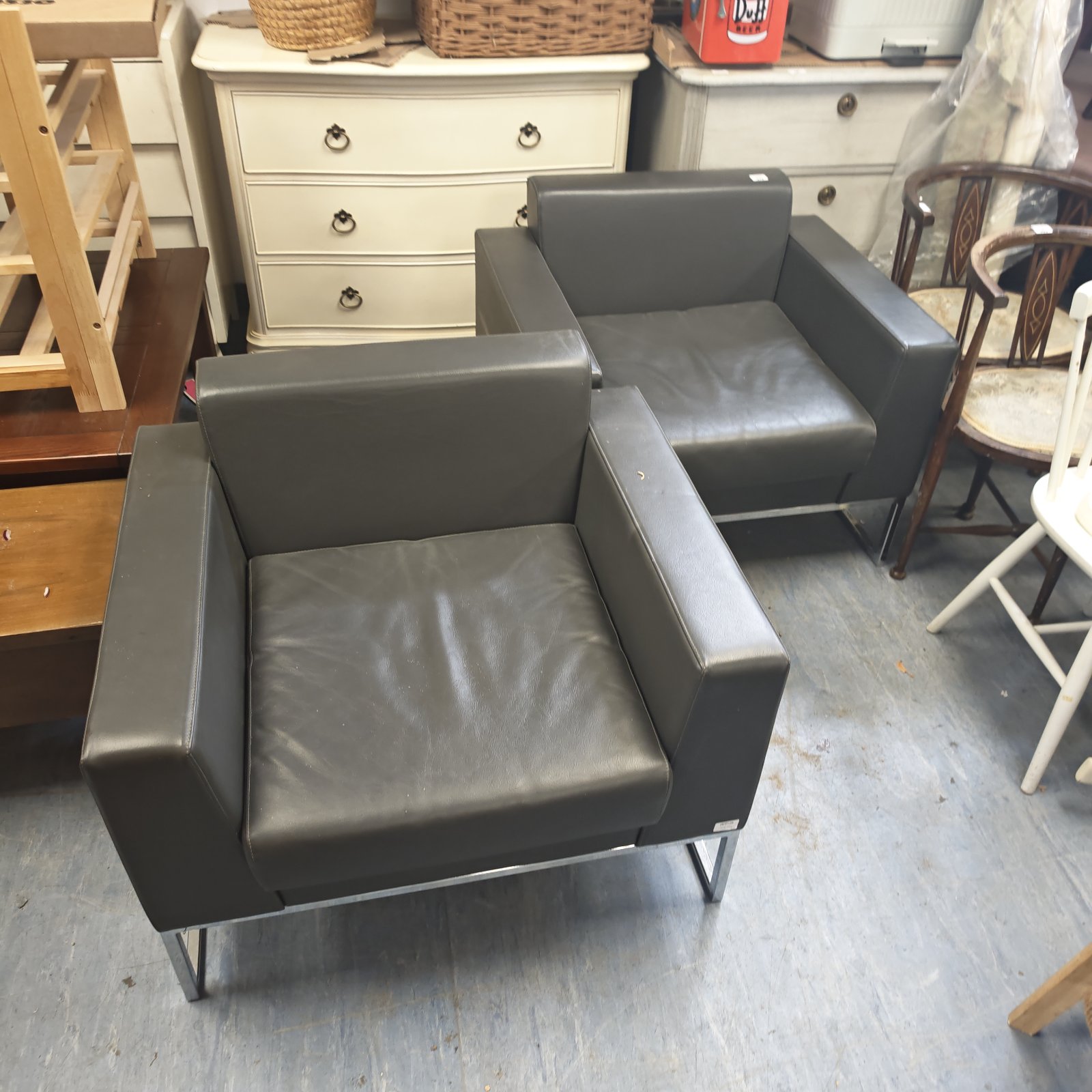 Pair of grey leather armchairs by Boss Design Group.