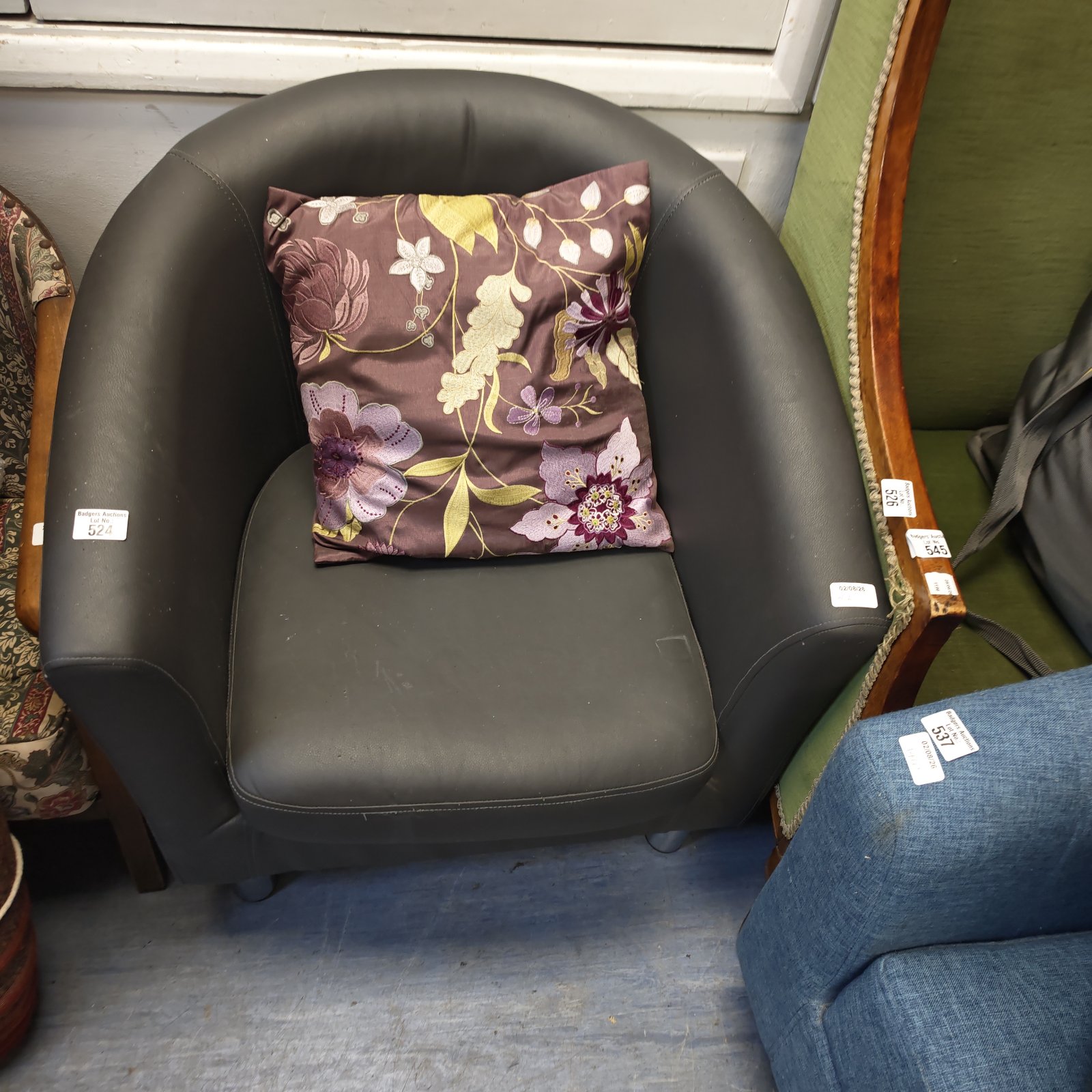 Vintage grey leather tin chair with a rounded seat.