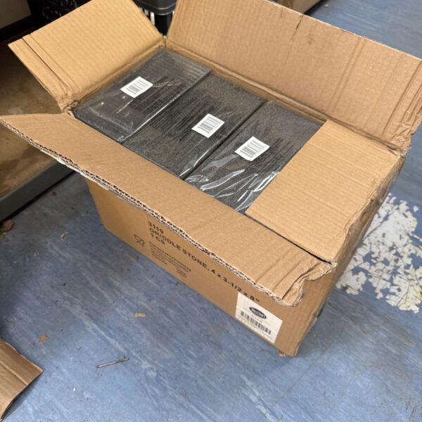 Box of new griddle stone grill cleaners for kitchen use.