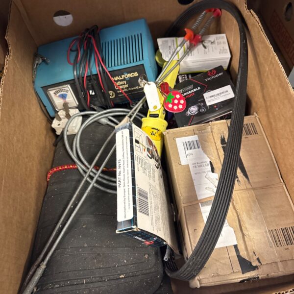 Halfords battery charger in a box of garage clearance items.