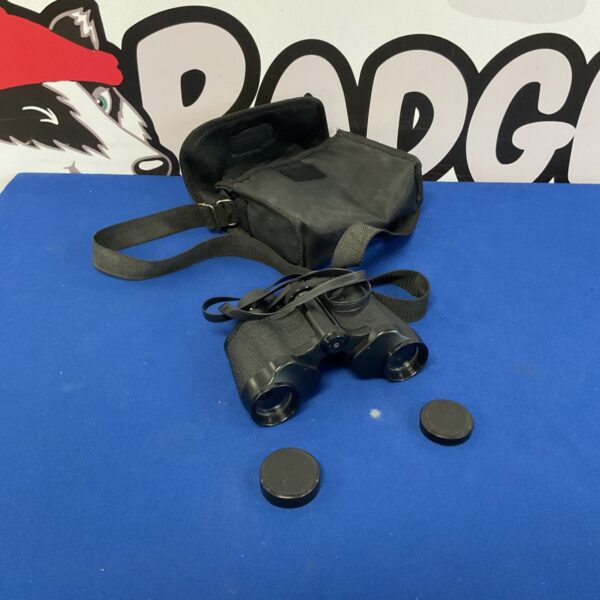 Vintage Halina Discovery binoculars with carrying case and strap.