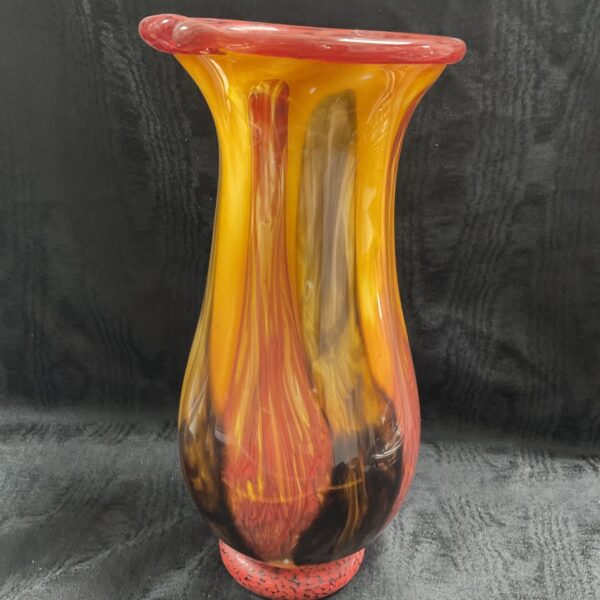 Vibrant hand-blown glass vase with red and yellow swirl design.