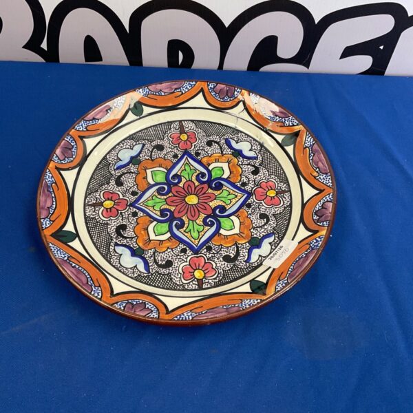 Vibrant hand-painted ceramic plate with floral design.