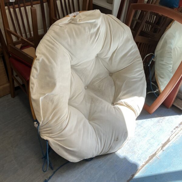 Vintage hanging bamboo chair with a cushioned seat.