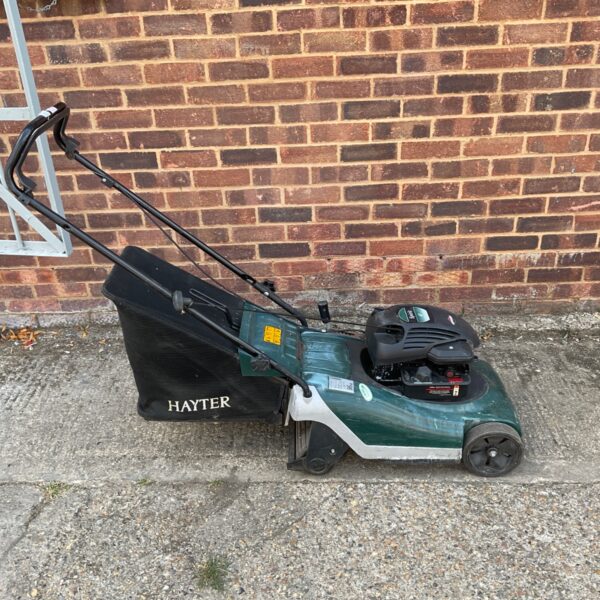 Hayter Harrier 41 petrol lawnmower in a garden setting.
