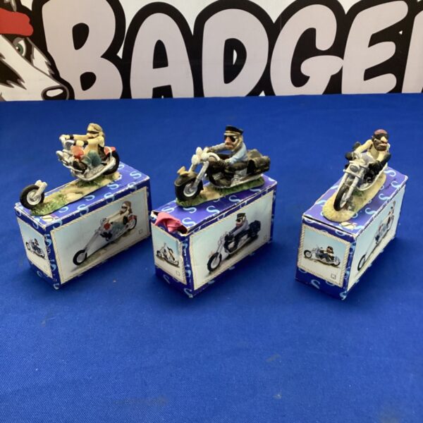 Three Hello Angel motorcyclist collectibles in original boxes.