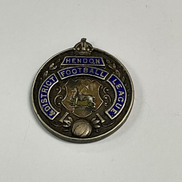 Vintage Hendon Football League silver badge with enamel detailing.