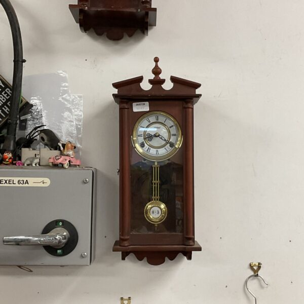 Vintage Highland chiming wall clock with Roman numerals.