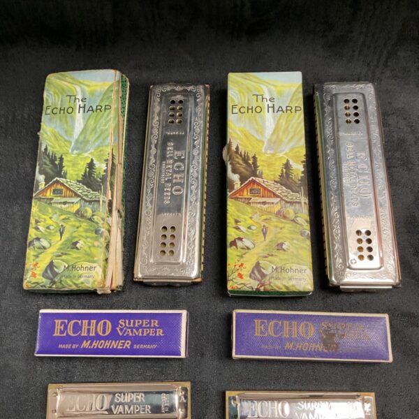Vintage Hohner Echo Harp harmonica with chalet scene cover.