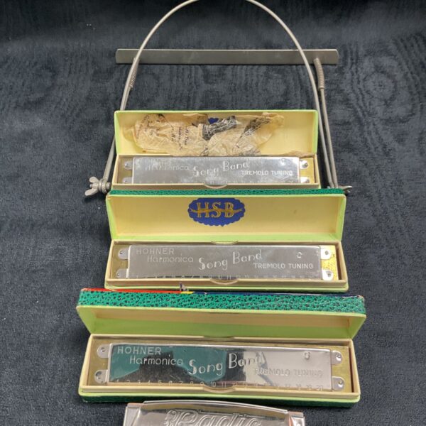Vintage Hohner harmonica collection with shoulder mount.