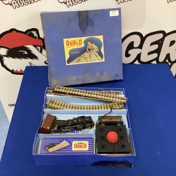 Vintage Hornby Dublo electric train set with locomotive and carriages.
