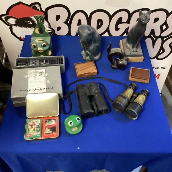 House clearance lot with cat ornaments, binoculars and a toad money box.