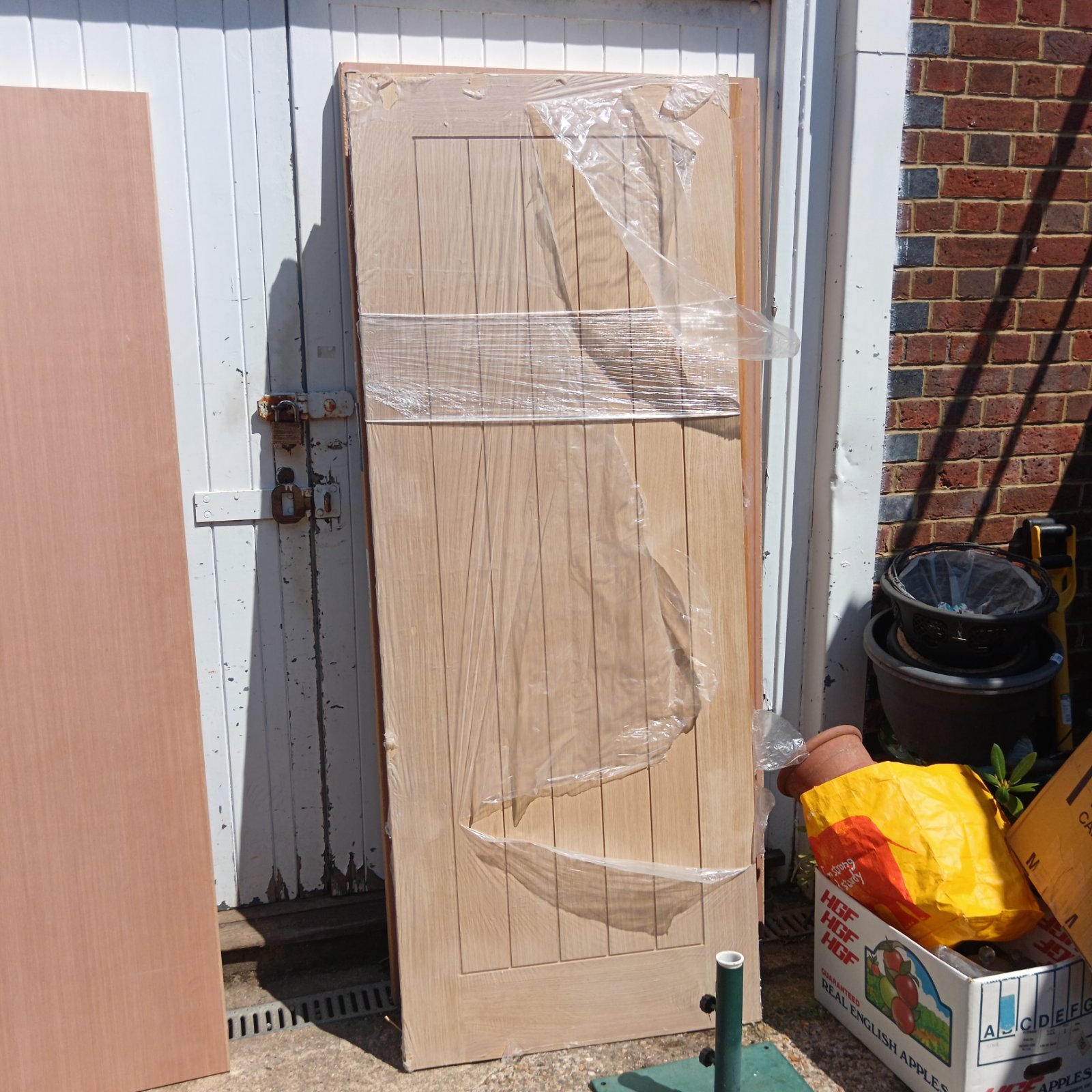 Howdens Holfenby oak fire door leaning against a wall.