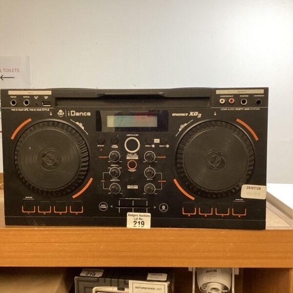 Black idance DJ controller with illuminated controls and integrated speakers.