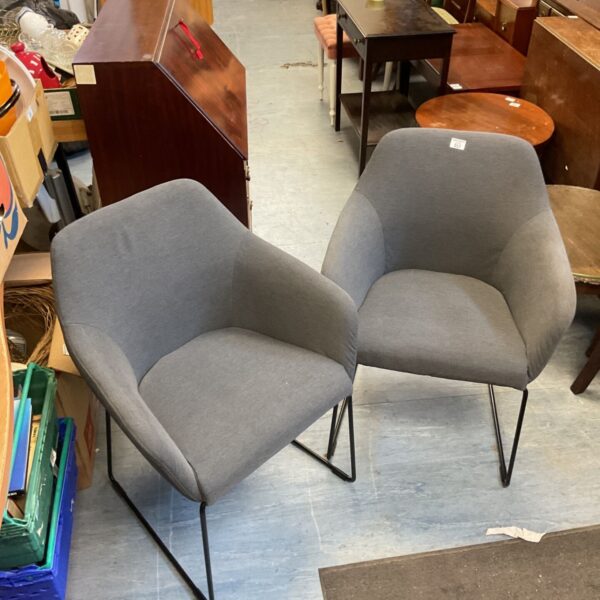Pair of gray Ikea Tossberg chairs with black metal legs.