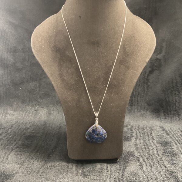 Close-up of imperial jasper pendant necklace with silver chain.