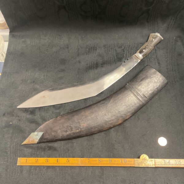 Large Indian Kukri knife with curved blade and wooden handle.