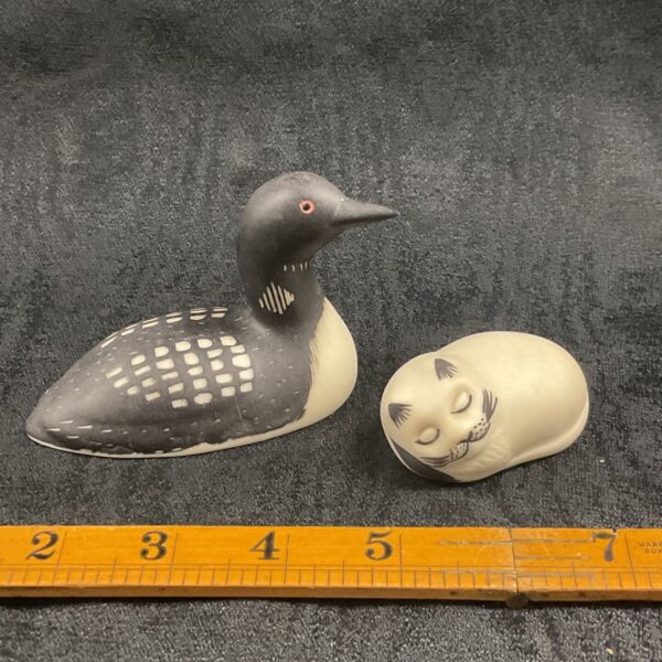 Isle of Arran pottery figures including a Great Northern Diver and a cat.