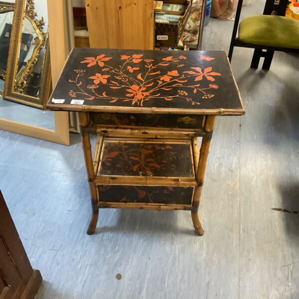 Lacquered Japanese bamboo side table with floral design.
