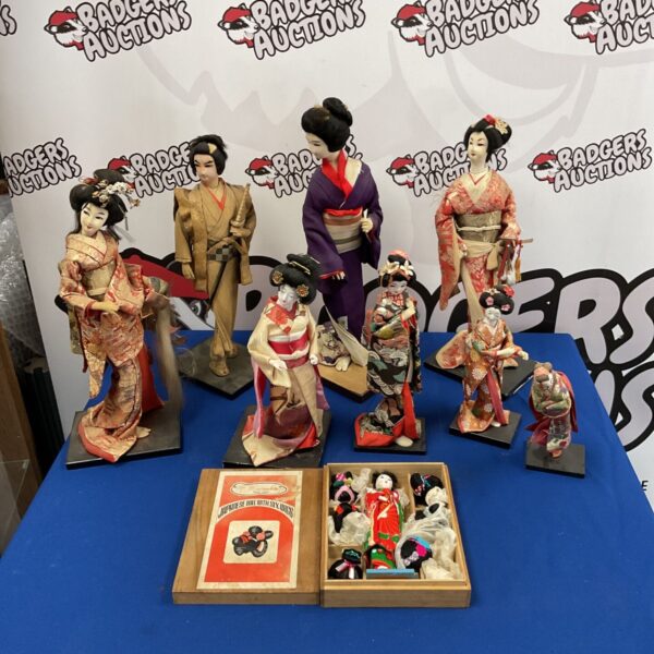Collection of vintage Japanese Geisha and Samurai dolls on display.
