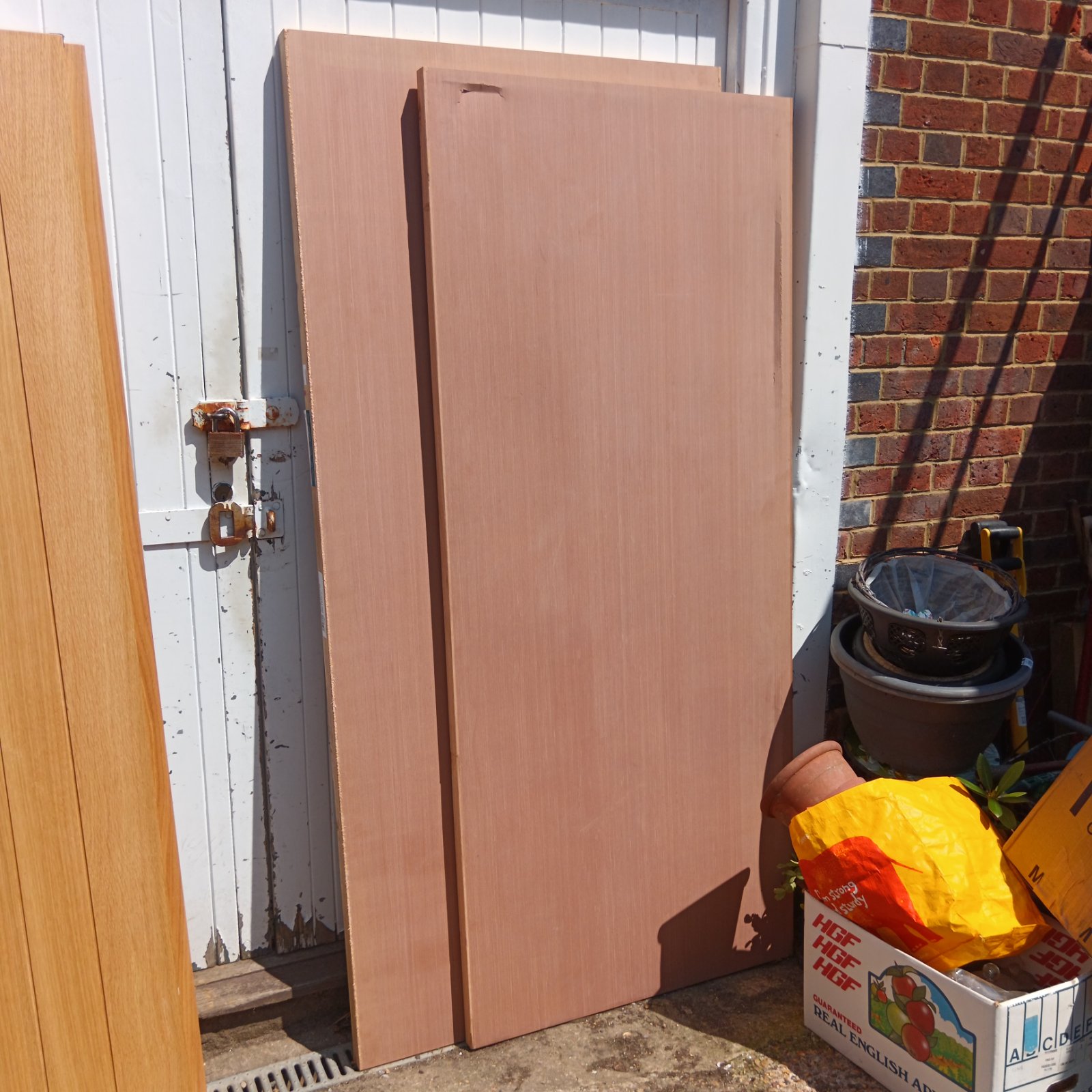 Lot of two Jeld-Wen fire doors leaning against a wall.