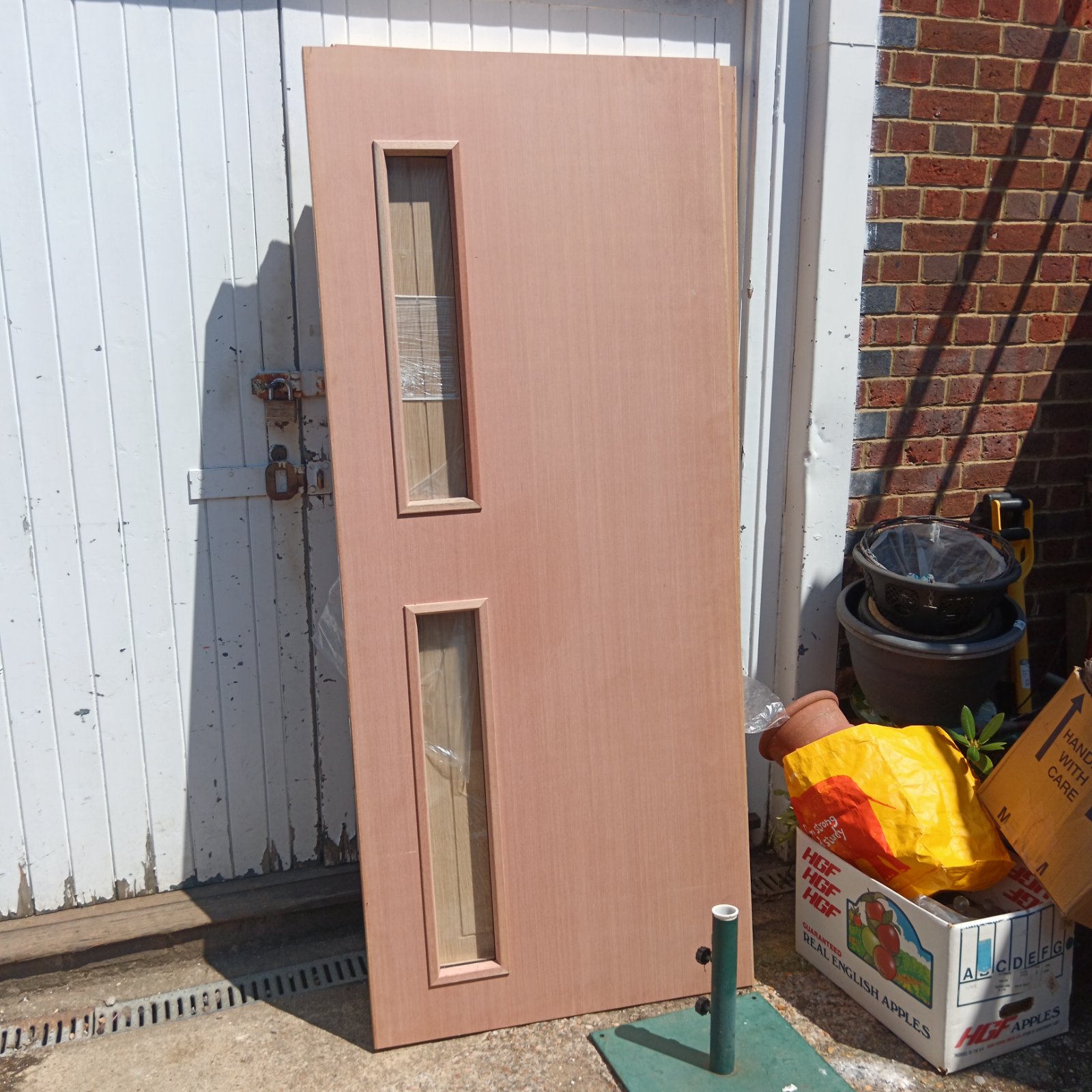 Jeldwen fire door leaning against a wall, showing glazed panels.