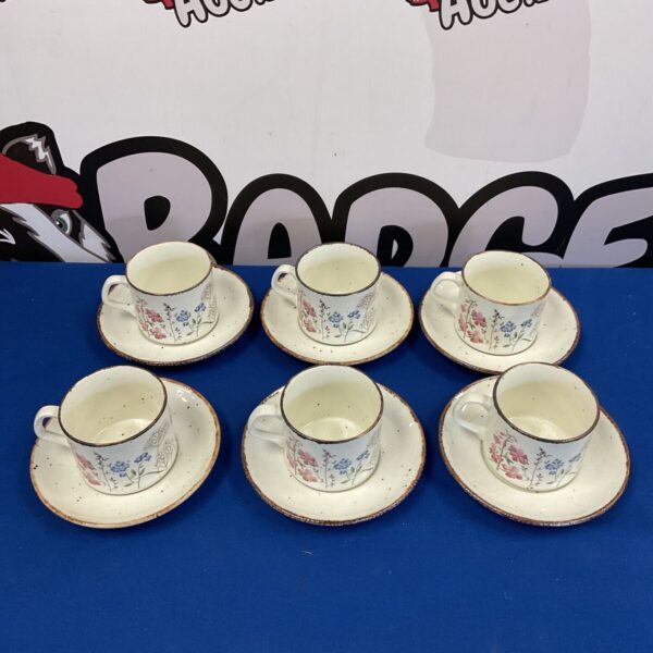 Vintage J G Meakin stoneware cups and saucers with floral pattern.