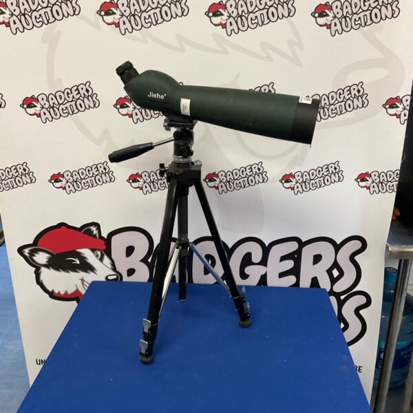 Green and black Jiehe spotting scope mounted on a tripod.