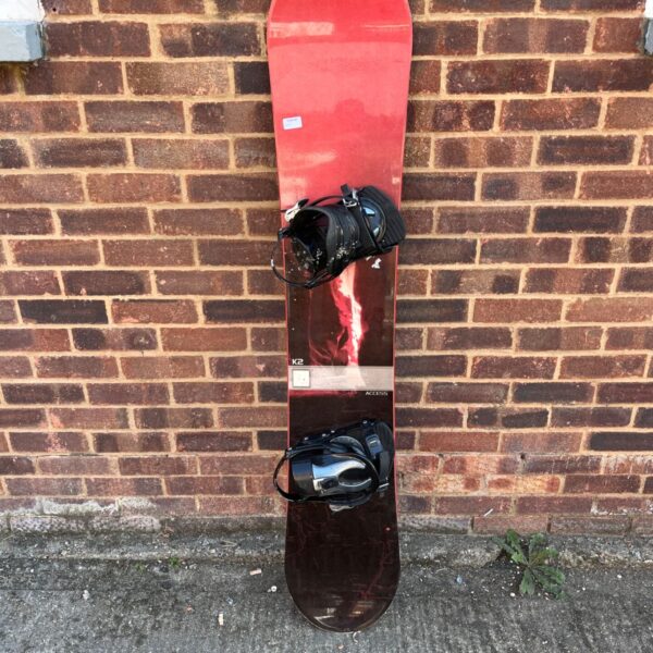 K2 Access snowboard with bindings, ready for winter sports.