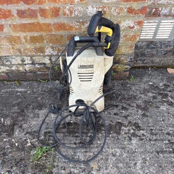 Karcher K2 compact pressure washer with hose attached.