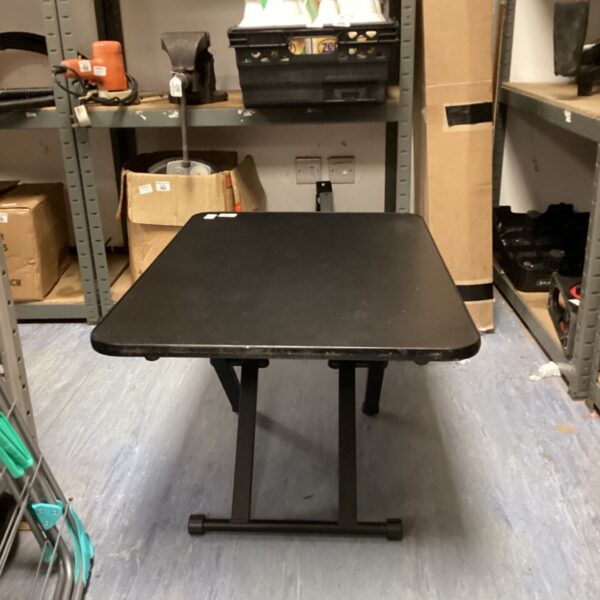 Black Kd essentials standing desk in a home office setting.