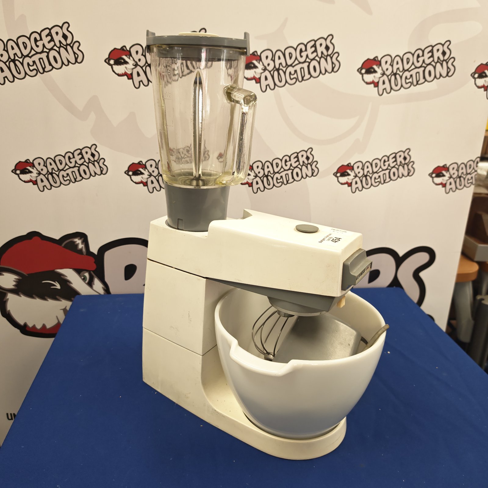 White Kenwood food mixer with attachments, vintage kitchen appliance.